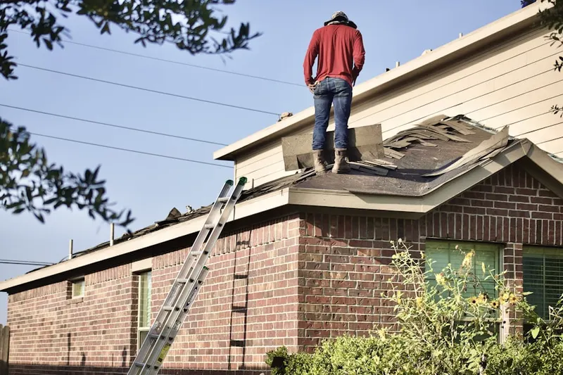 Professional roofer working on a residential roof in Tomball